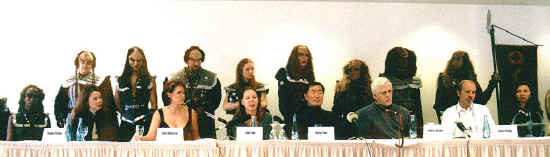 click for close up: the panel at the press conference (Richard Arnold sits on the far right, off screen)